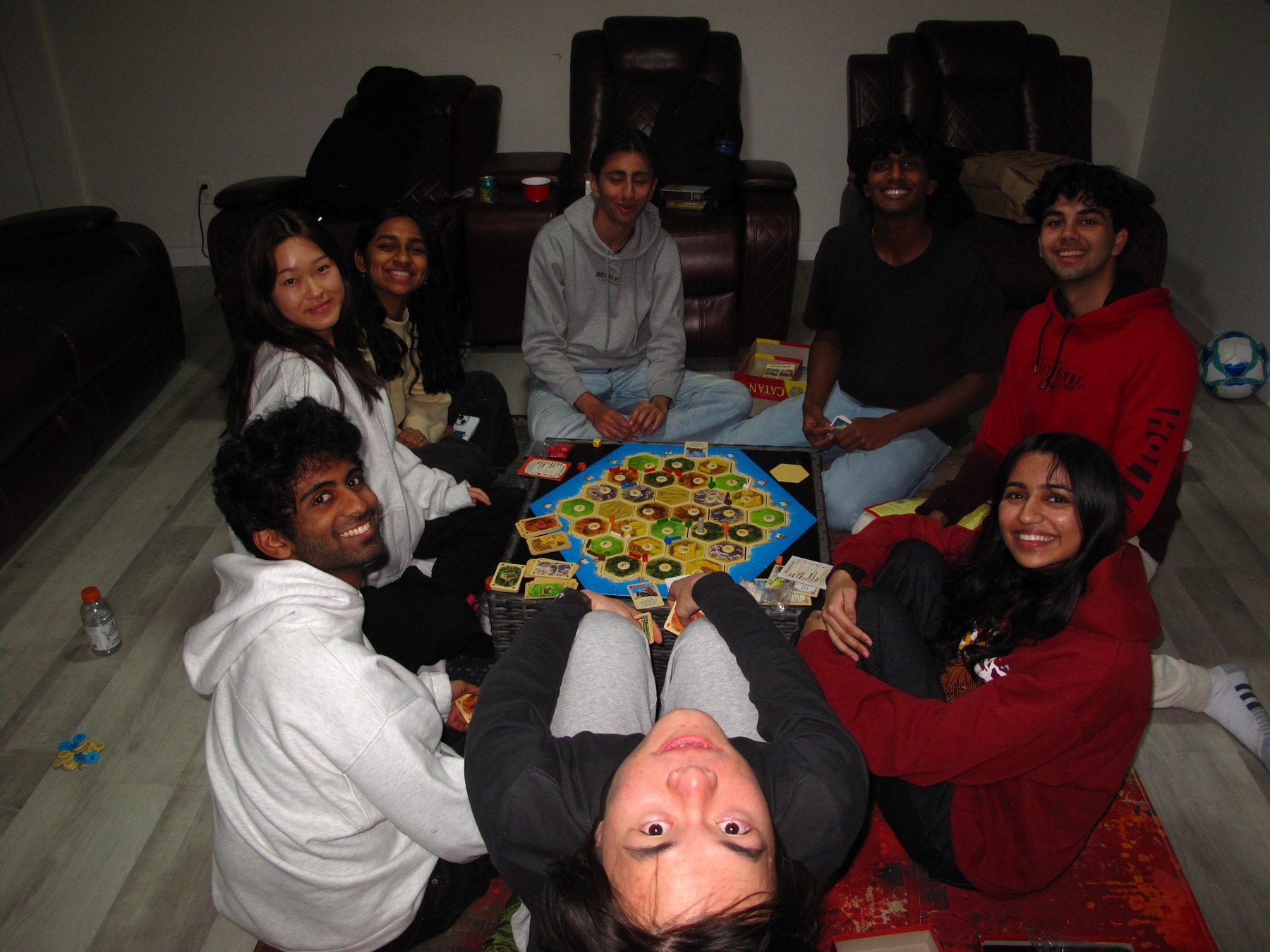 Launchpad members around a board game