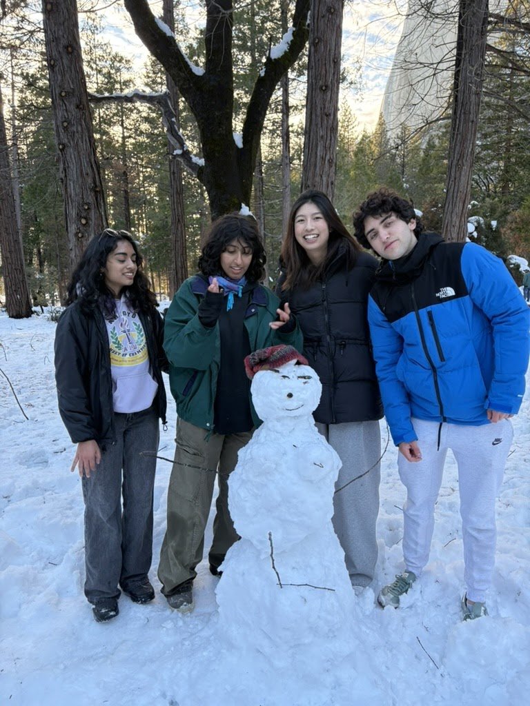 Launchpad members building a snowman on the winter retreat
