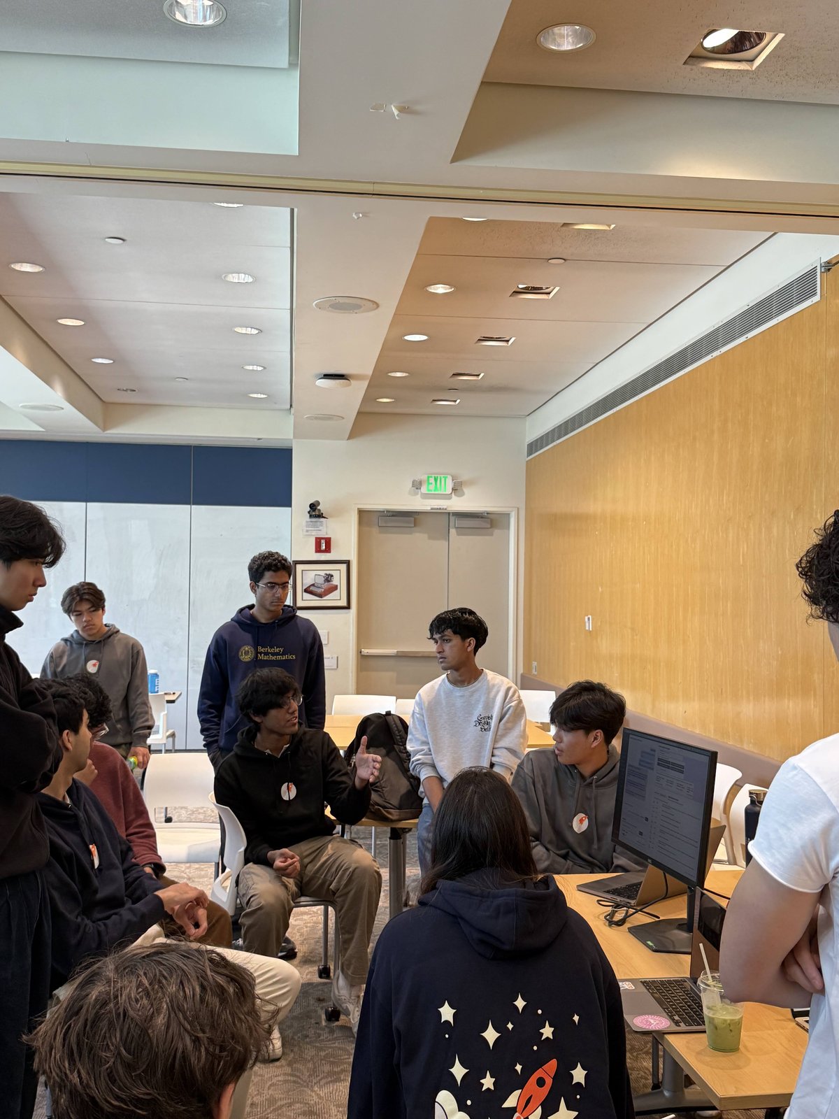 Members gathered around a table at a Launchpad event, mid-conversation