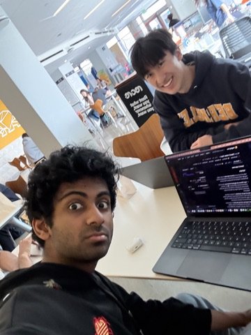 Two Launchpad members working on a laptop full of code